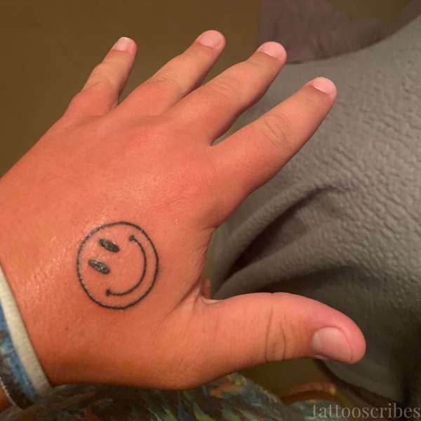 smiley face tattoo meaning